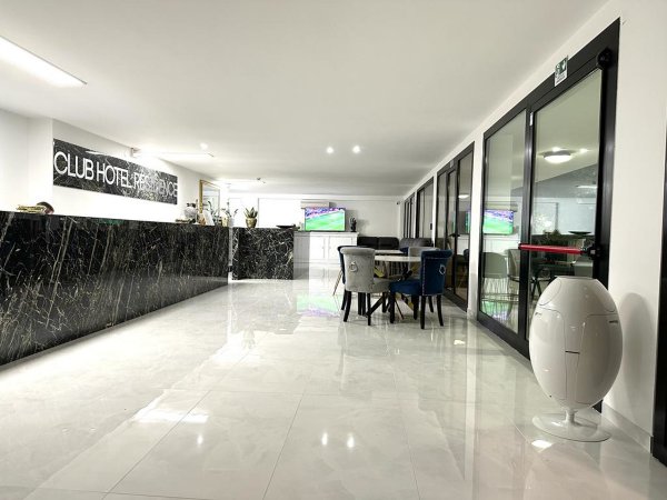 Reception moderna con tavoli e sedie.