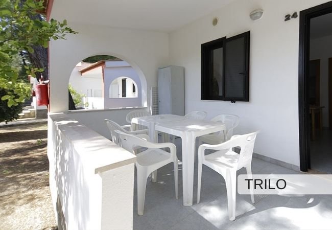 Veranda con tavolo bianco e quattro sedie.